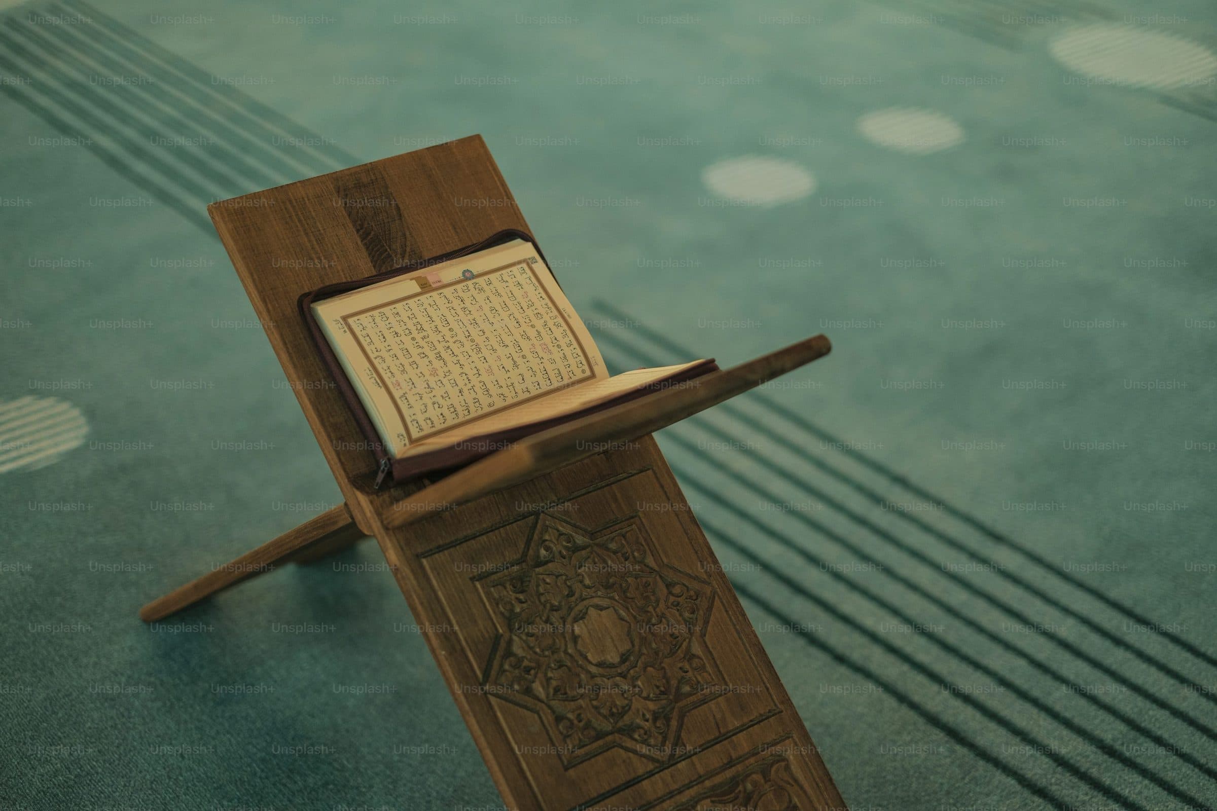 An open Qur'an on a wooden reading stand