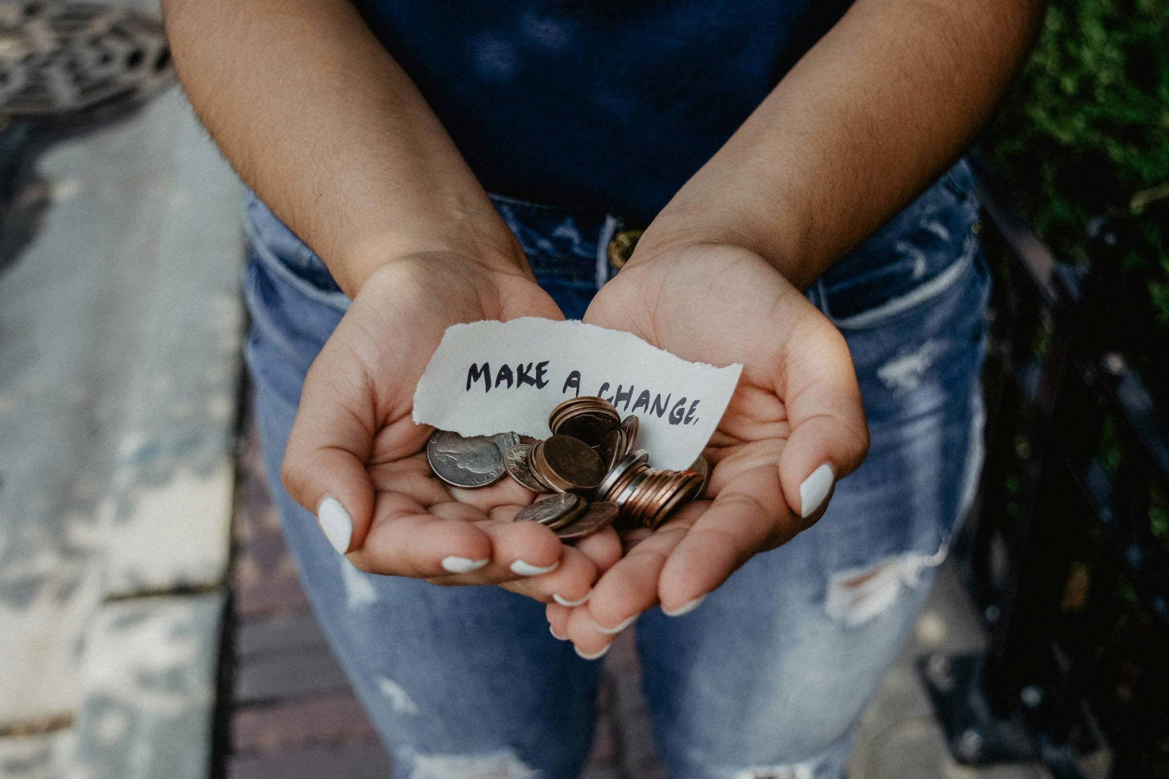 A hand placing a note into a box