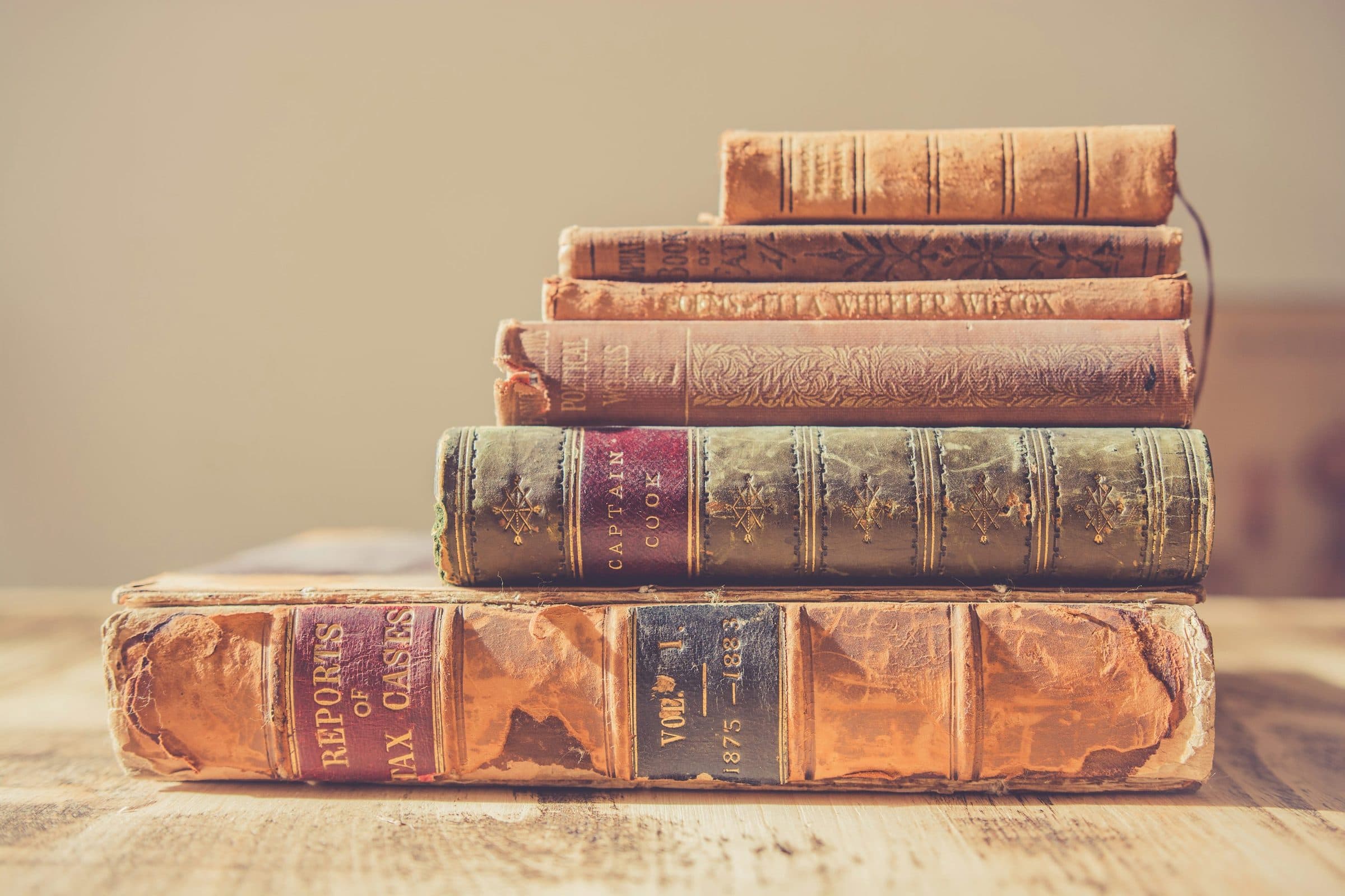 A stack of books on a plain surface